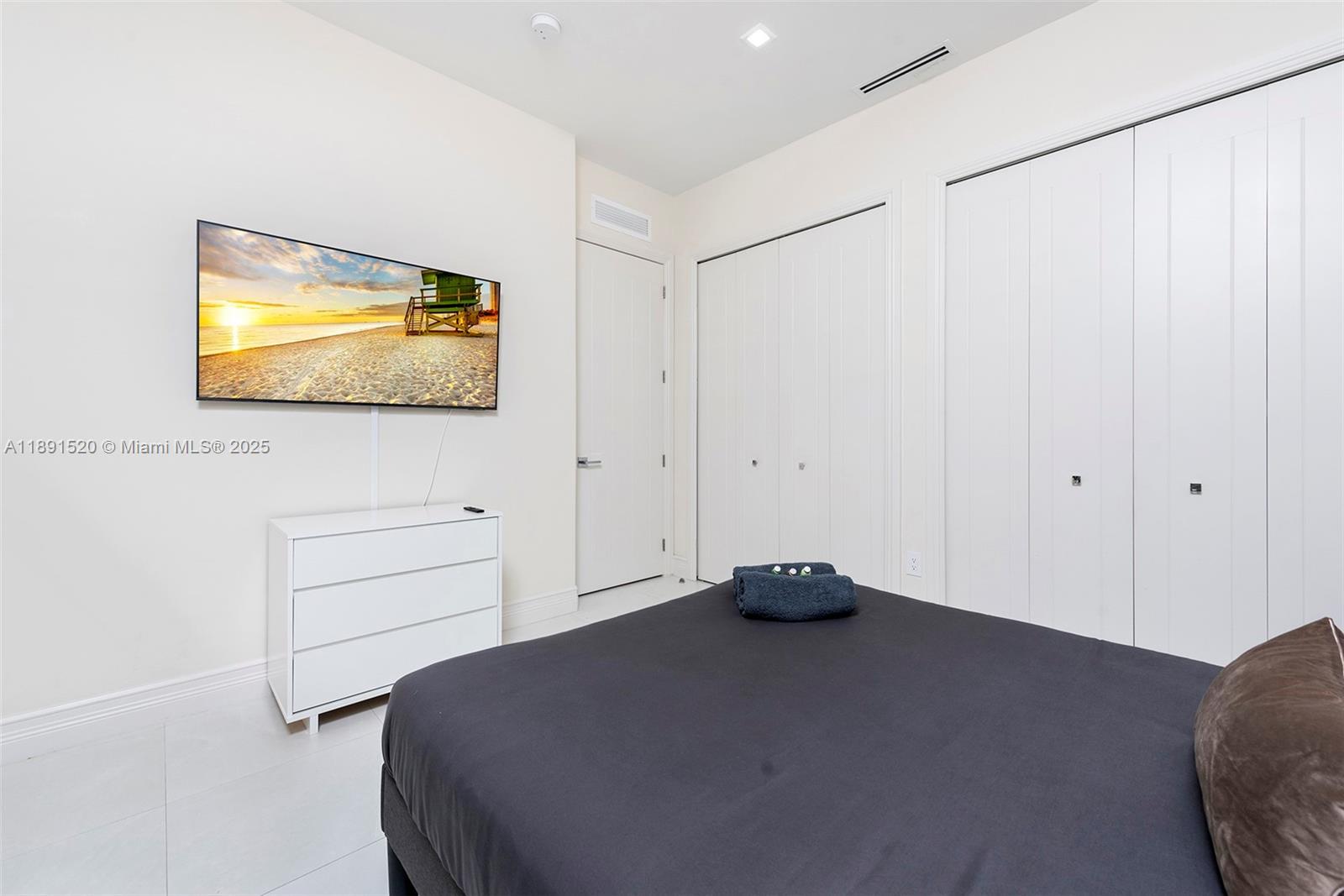 6529 Southwest 30th Street Miami, FL 33155 - Photo 18 of 45 a bedroom with a bed and a flat screen tv