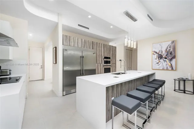 a kitchen with stainless steel appliances a refrigerator and a stove