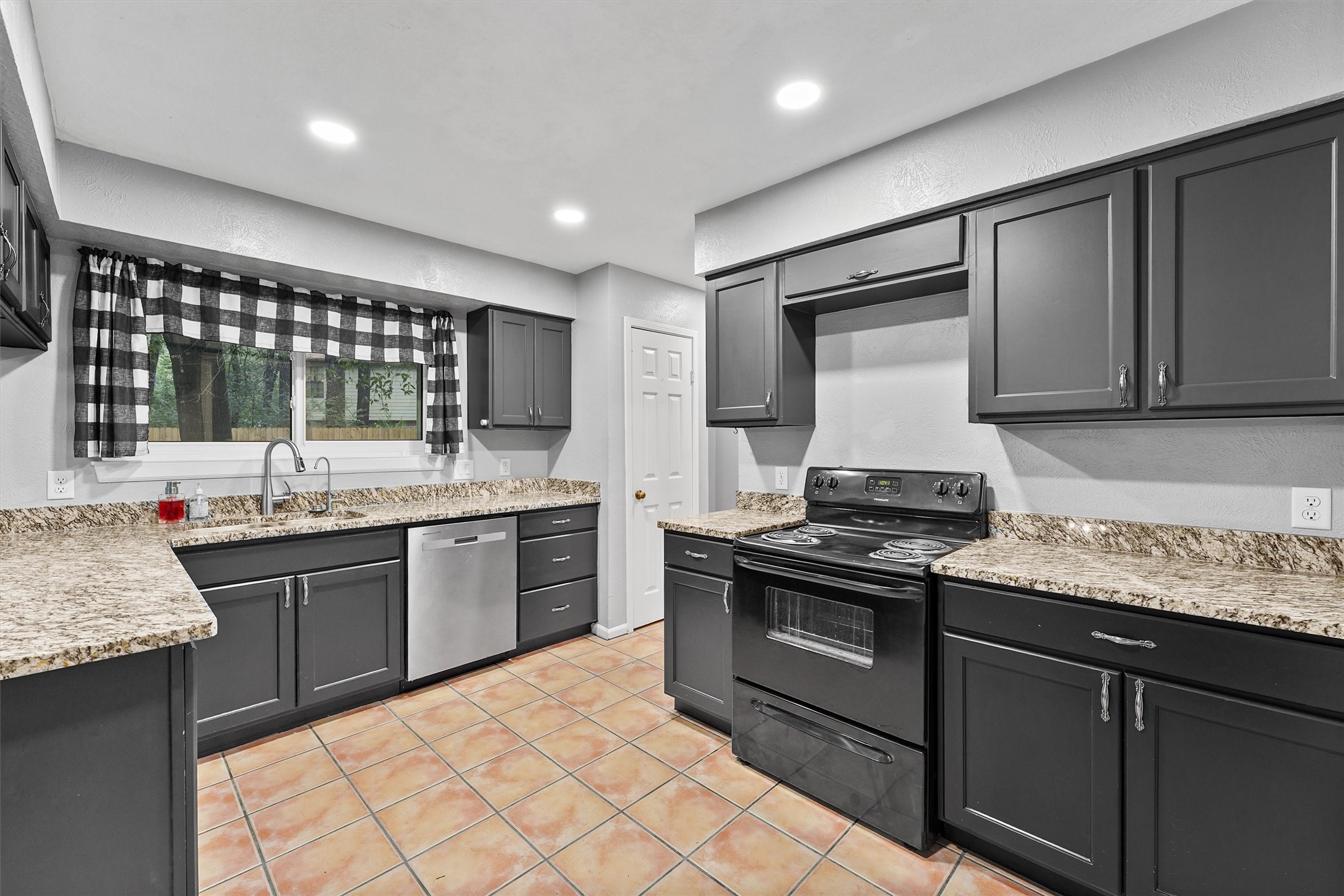 3702 Ember Spring Drive Kingwood, TX 77339 - Photo 2 of 29 Beautiful dark colored cabinets with tons of storage.