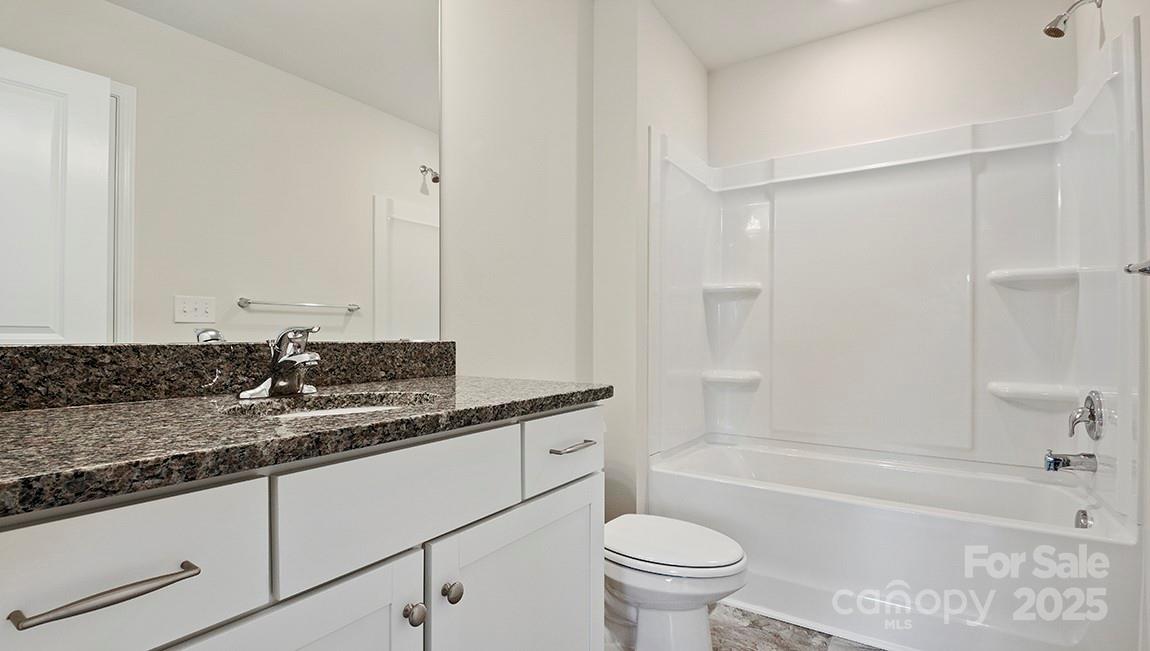 366 Lagoon Road Fletcher, NC 28732 - Photo 18 of 30 a bathroom with a granite countertop sink a toilet and bathtub