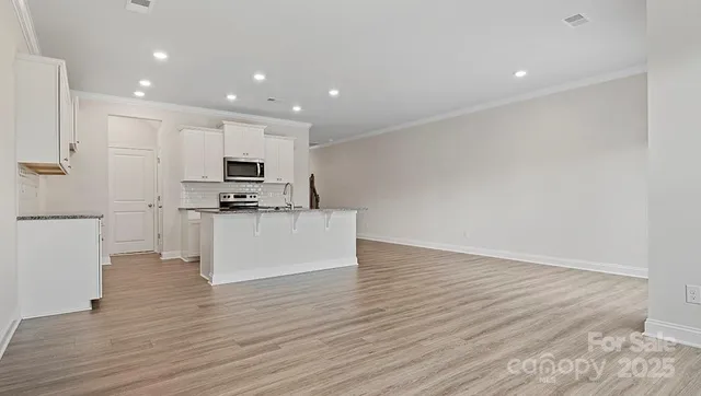 a view of kitchen with microwave and cabinets