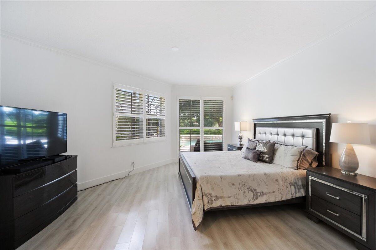 2514 Players Court Wellington, FL 33414 - Photo 12 of 30 a bedroom with a bed and wooden floor
