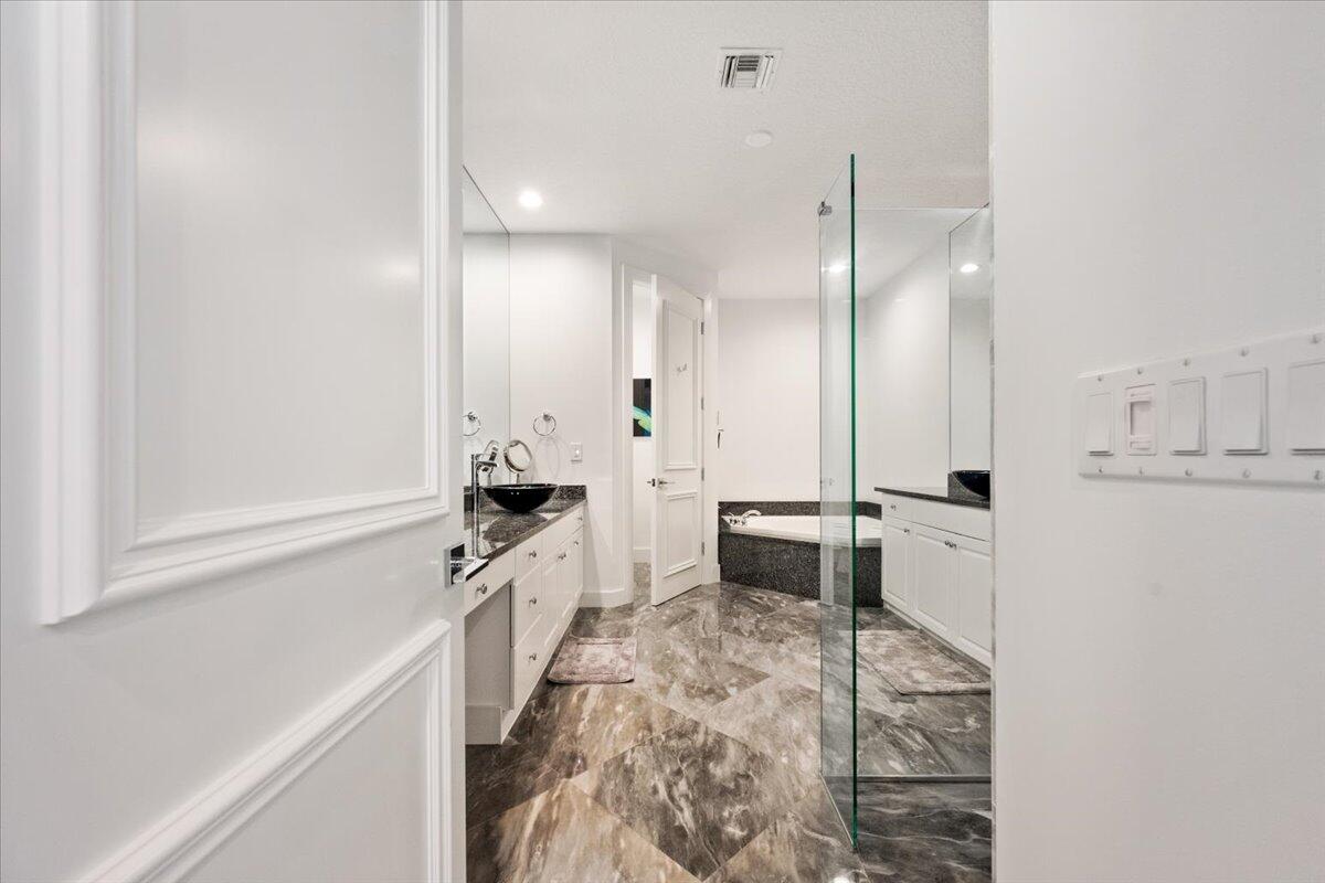 2514 Players Court Wellington, FL 33414 - Photo 14 of 30 a large white kitchen with granite countertop a stove a sink a refrigerator and white cabinets with wooden floor