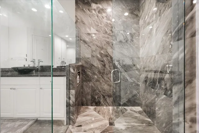 a bedroom with a large bed and wooden floor