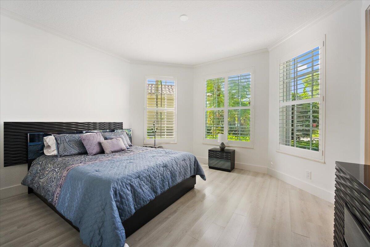 2514 Players Court Wellington, FL 33414 - Photo 17 of 30 a bedroom with a large bed and wooden floor