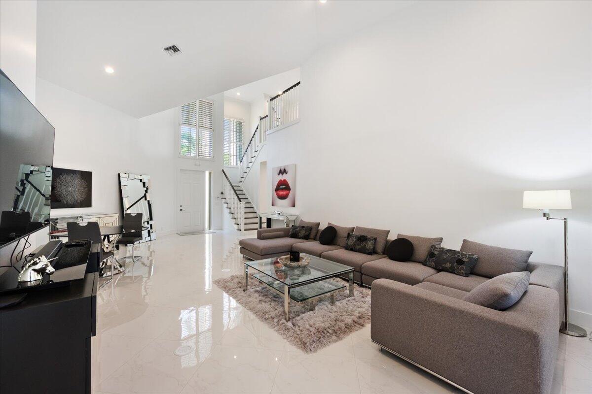 2514 Players Court Wellington, FL 33414 - Photo 2 of 30 a living room with furniture and a flat screen tv