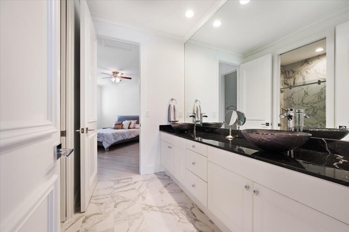 2514 Players Court Wellington, FL 33414 - Photo 22 of 30 a en suite bathroom with double sink and a mirror