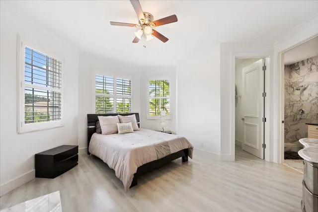 a bathroom with a granite countertop sink a mirror a vanity and shower