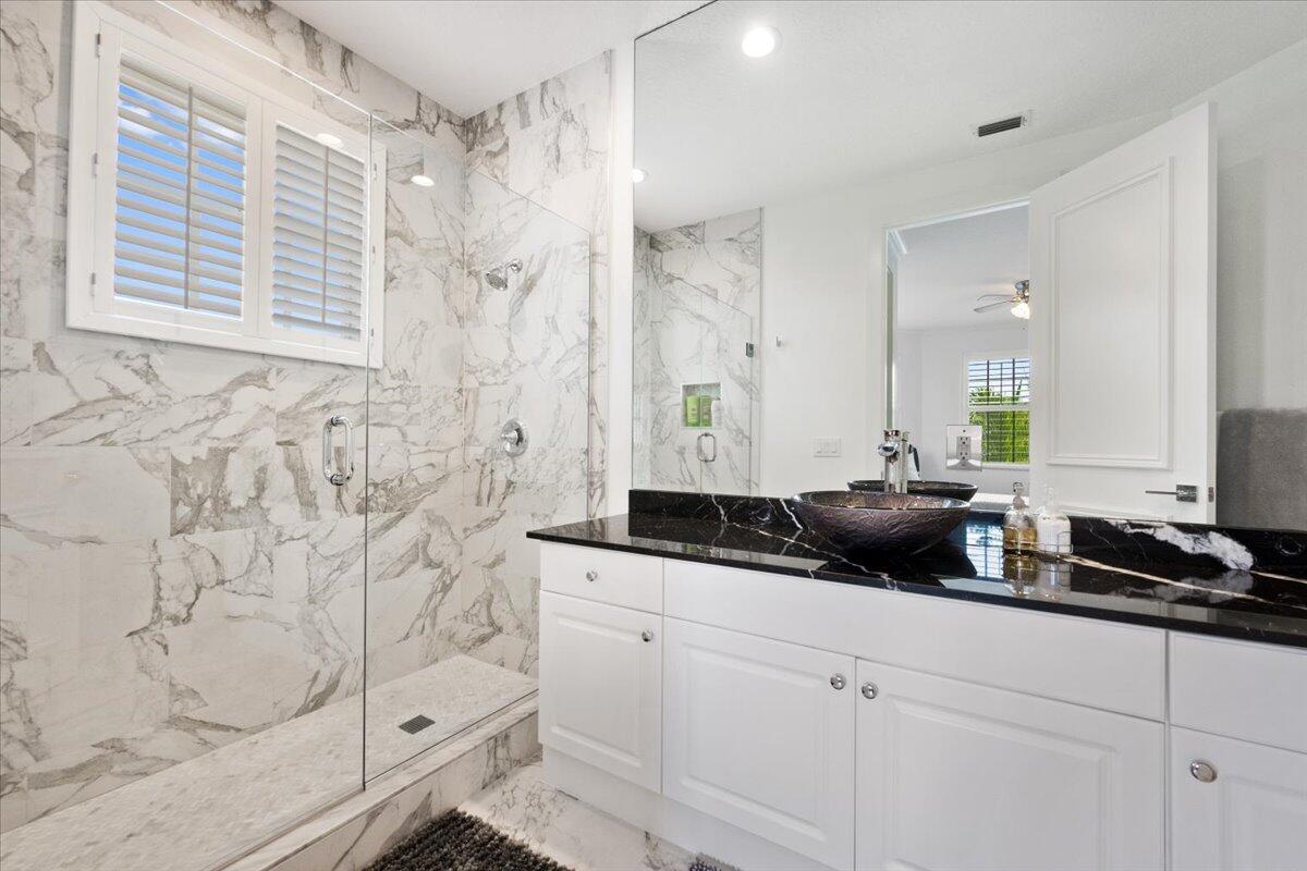 2514 Players Court Wellington, FL 33414 - Photo 25 of 30 a bathroom with a granite countertop sink a mirror a vanity and shower
