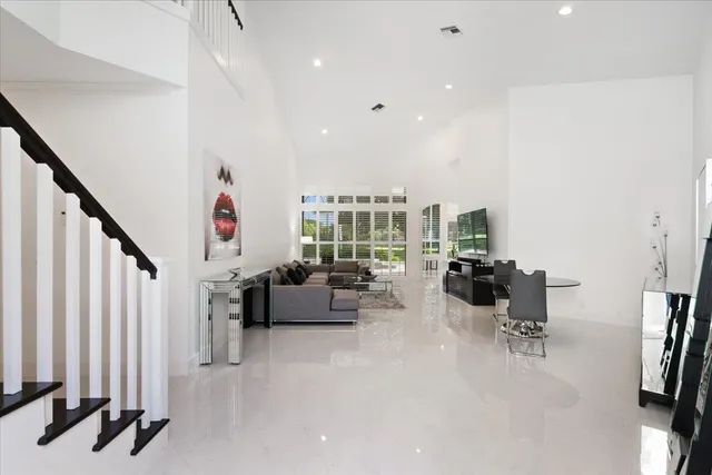 a very nice looking room with a large window and couch