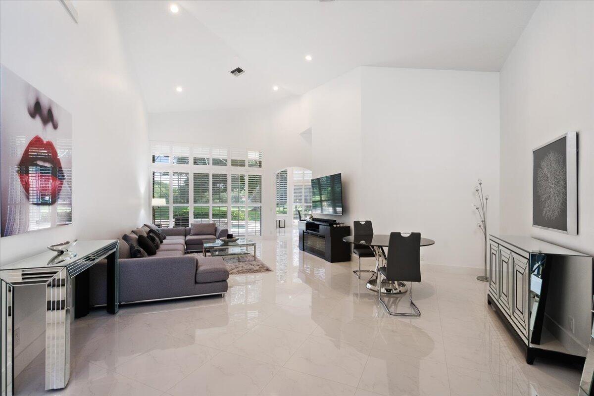 2514 Players Court Wellington, FL 33414 - Photo 4 of 30 a living room with furniture and a flat screen tv