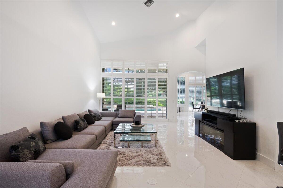 2514 Players Court Wellington, FL 33414 - Photo 5 of 30 a living room with furniture and a flat screen tv