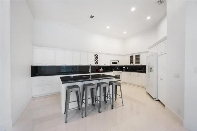 a kitchen with a table and chairs in it