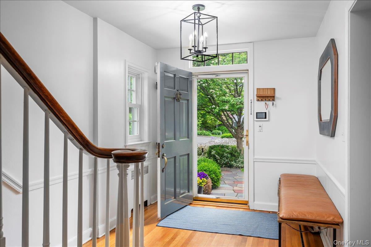 49 Eton Road Larchmont, NY 10538 - Photo 3 of 34 a view of a hallway with wooden floor and staircase