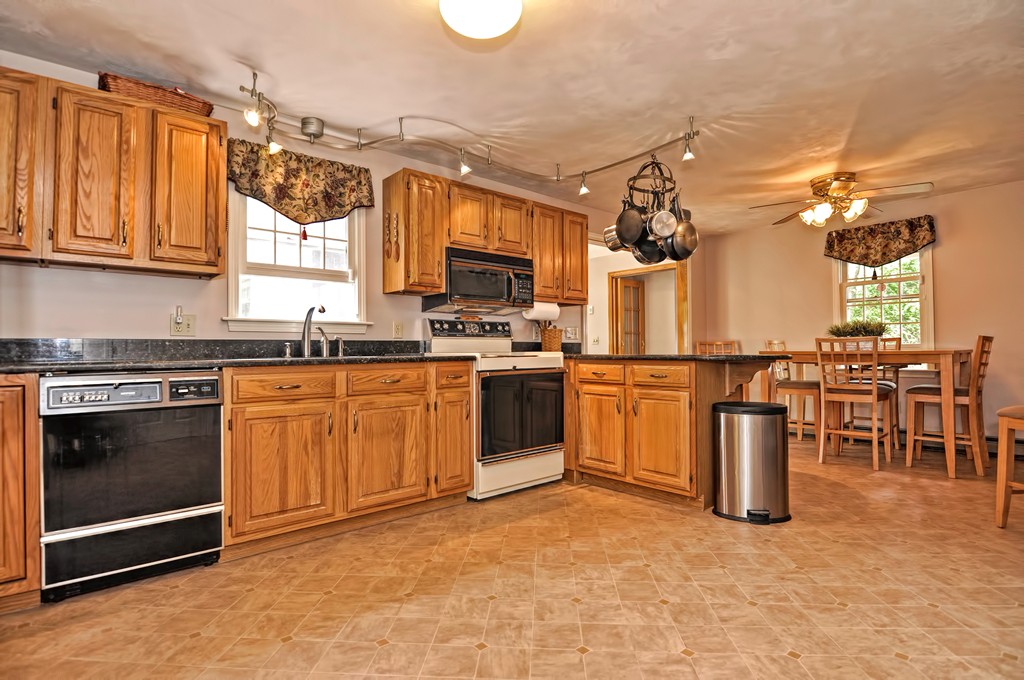 15 Dana Road Sandwich, MA 02644 - Photo 3 of 30 a kitchen with a stove top oven sink and cabinets