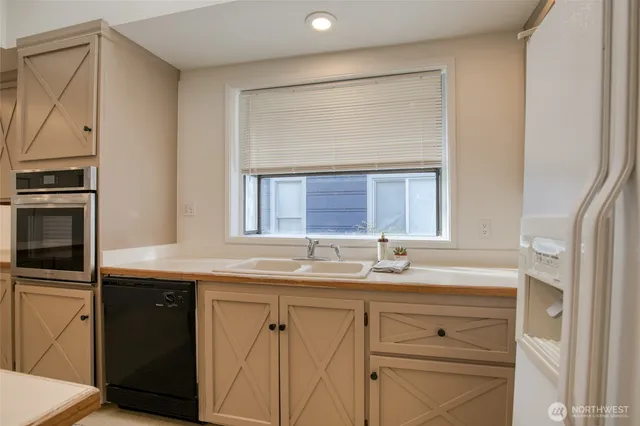 a kitchen with a sink and a refrigerator