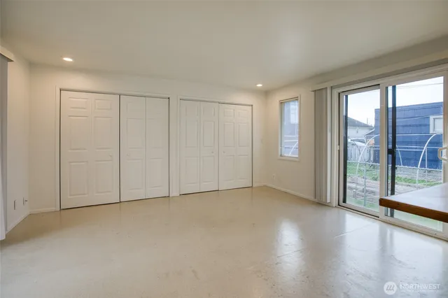 a view of an empty room with glass door
