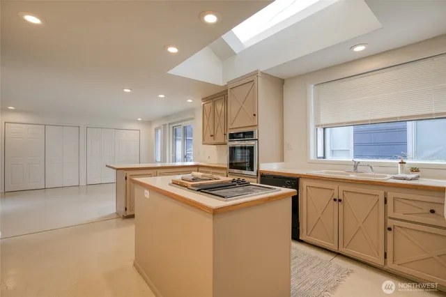 a kitchen that has a sink and a stove in it
