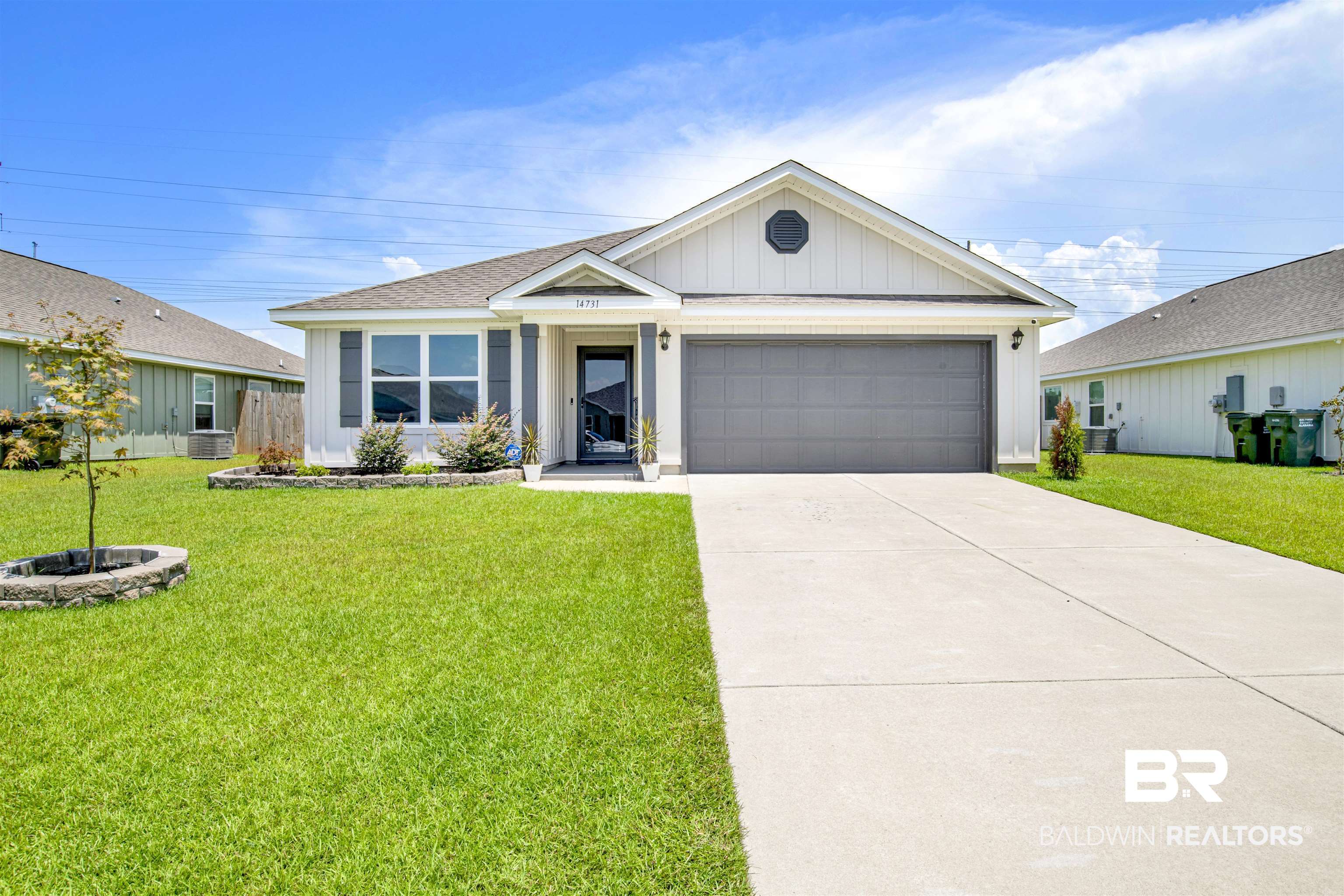 View of front of house featuring a garage and a front lawn