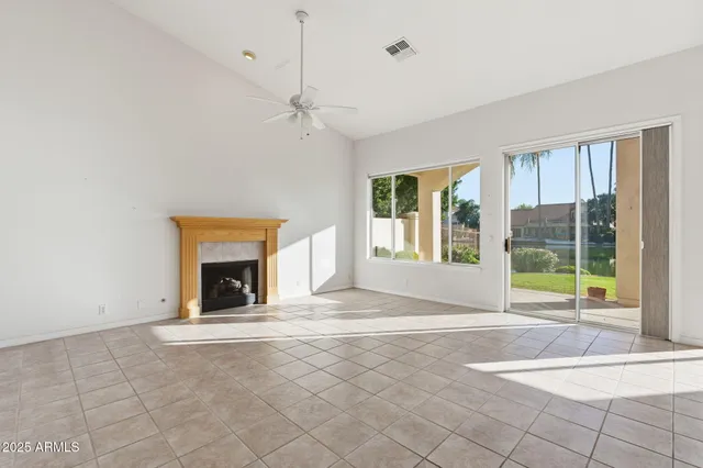 a view of empty room with a fireplace and window