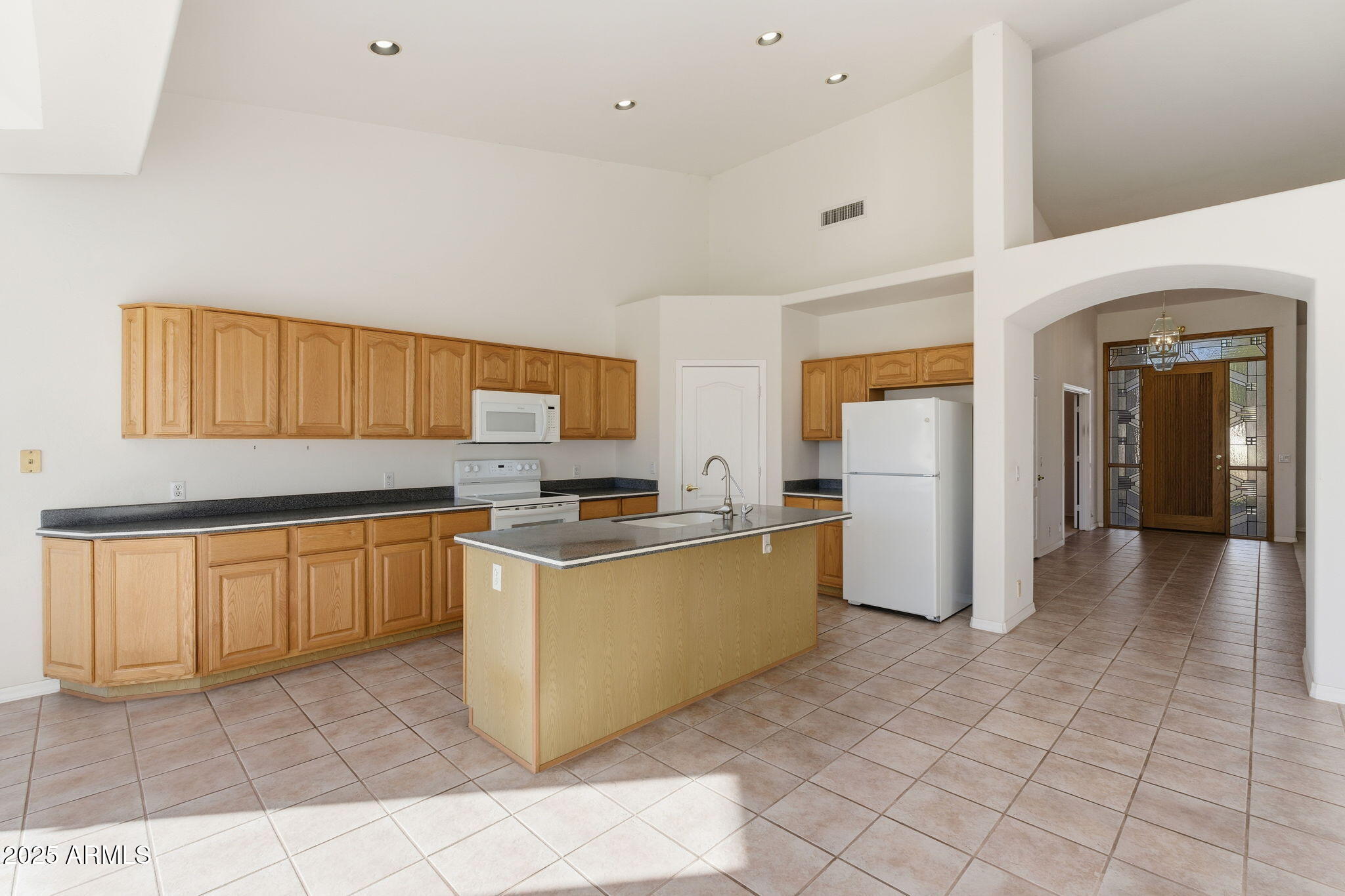 2011 East Clipper Lane Gilbert, AZ 85234 - Photo 24 of 51 a kitchen with stainless steel appliances granite countertop a refrigerator and a sink