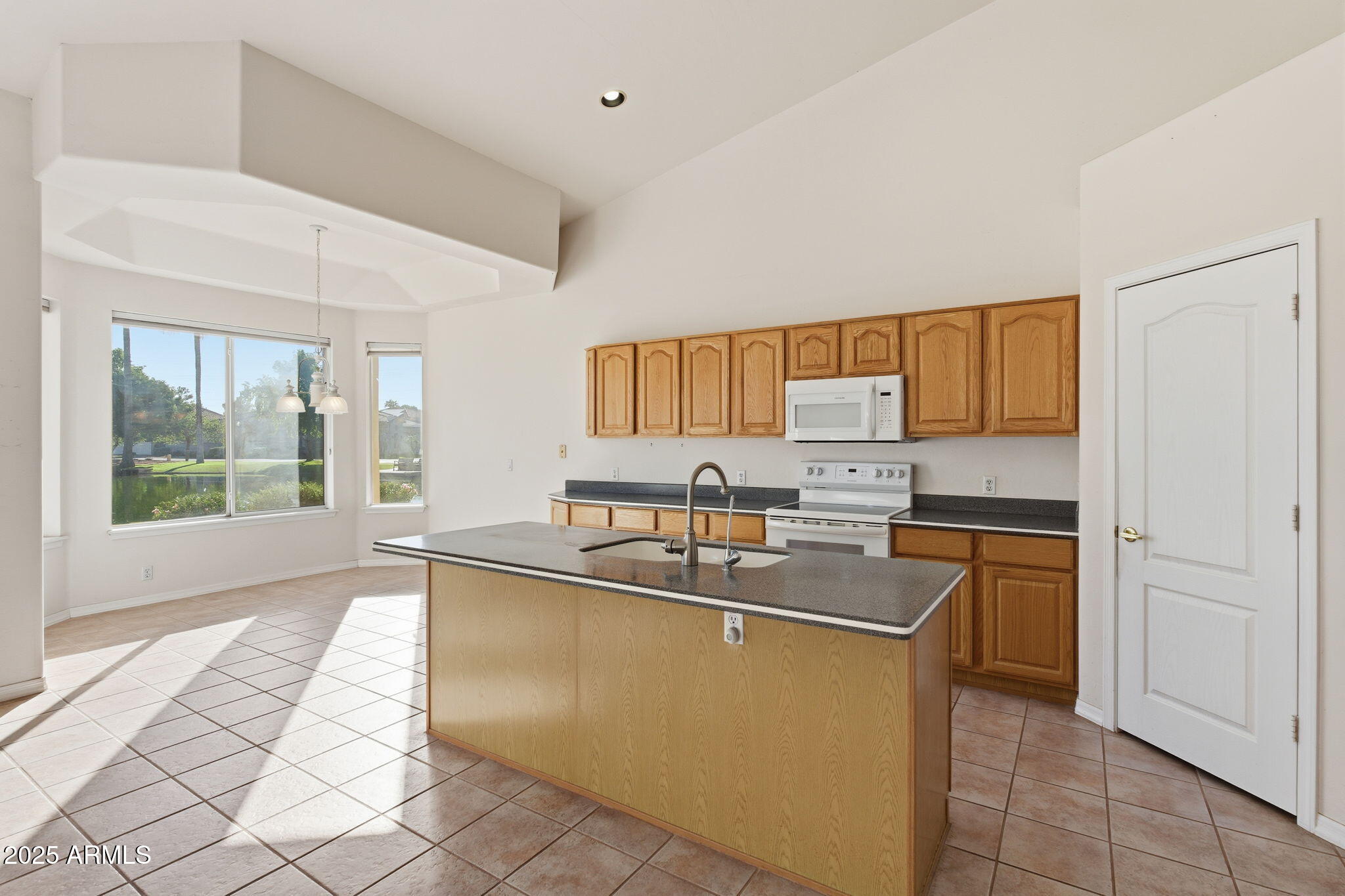 2011 East Clipper Lane Gilbert, AZ 85234 - Photo 26 of 51 a kitchen with stainless steel appliances granite countertop a sink and a stove