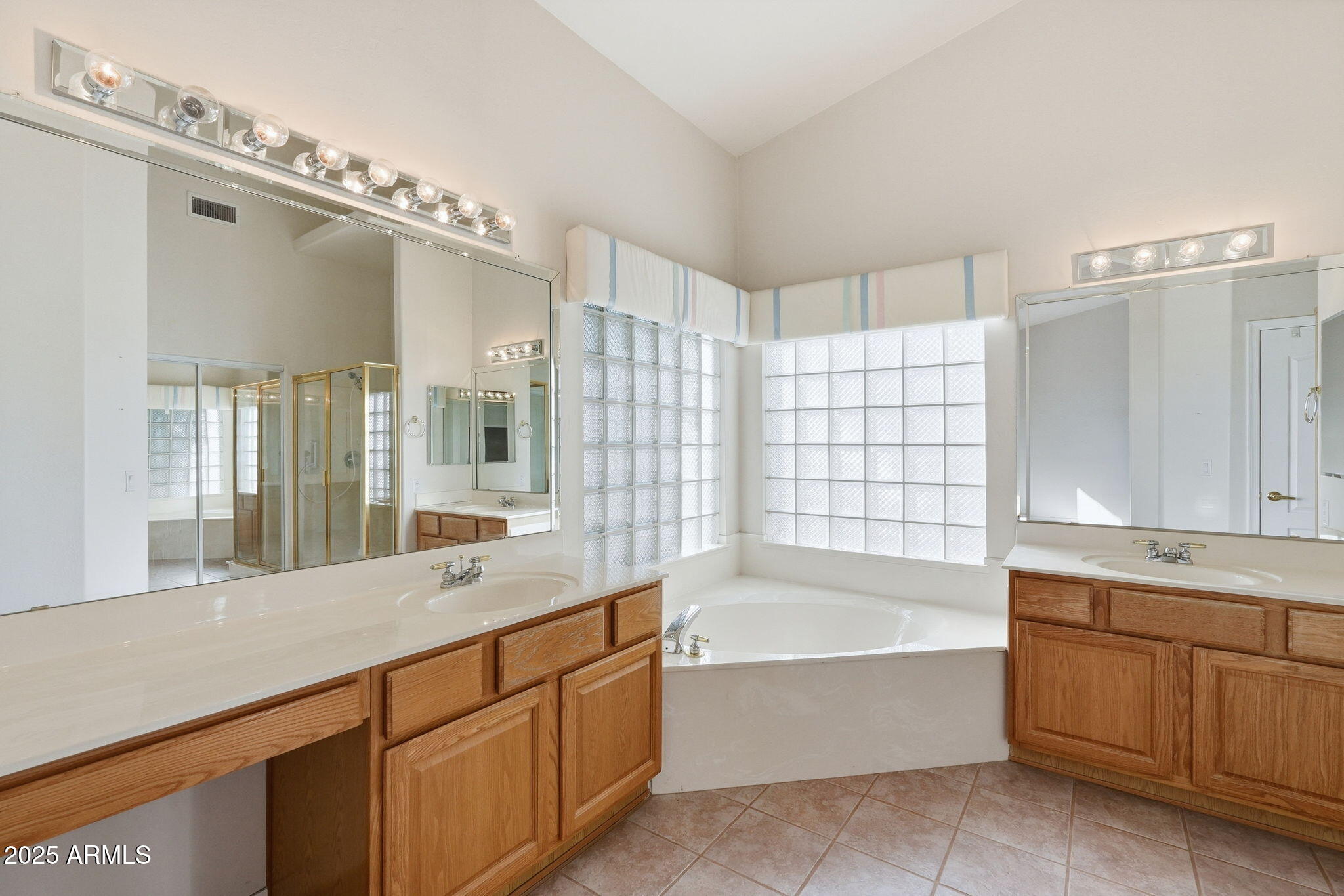 2011 East Clipper Lane Gilbert, AZ 85234 - Photo 32 of 51 a spacious bathroom with a bathtub a double vanity sink and mirror