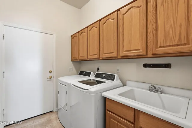 a utility room with sink dryer and washer