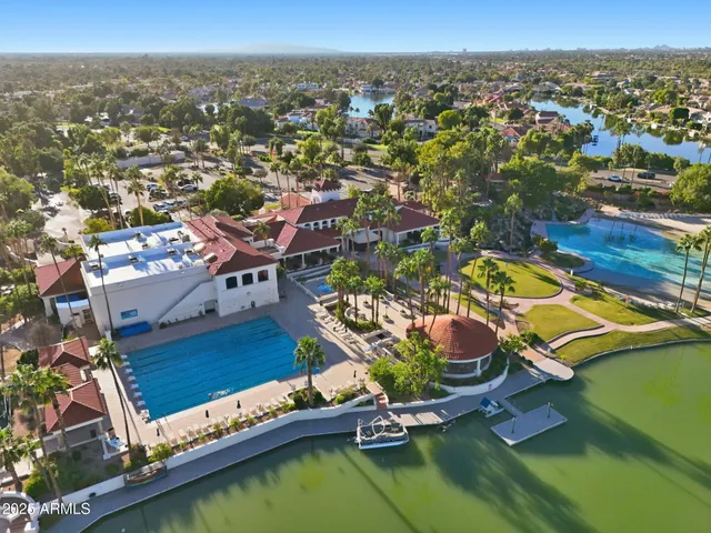 an aerial view of a swimming pool with outdoor seating