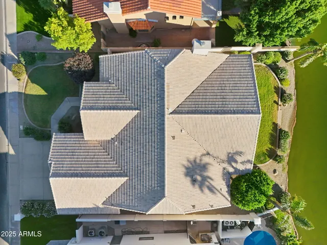 an aerial view of residential houses with outdoor space and ocean view