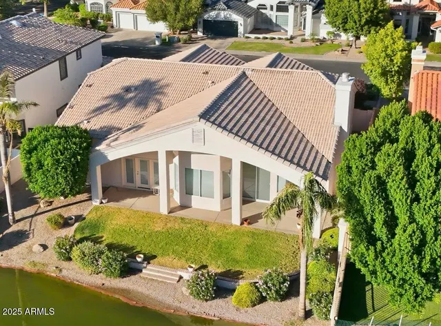 an aerial view of a house with garden space and street view