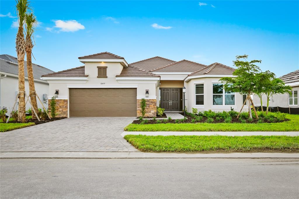 a front view of a house with a yard and garage