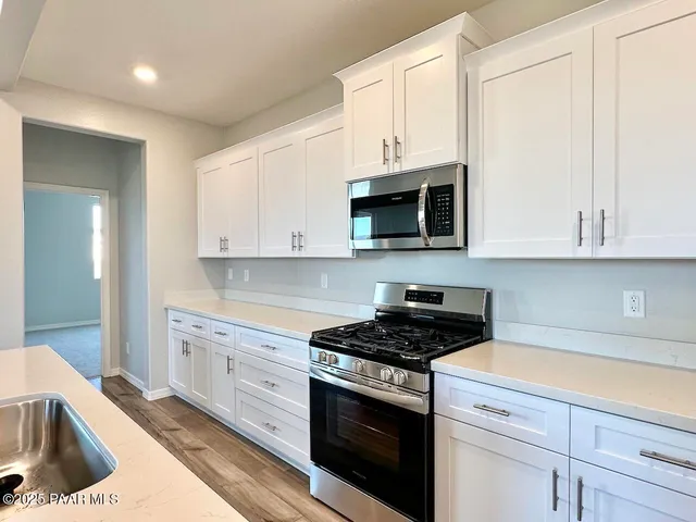 a stove top oven sitting inside of a kitchen