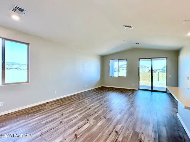 a large kitchen with stainless steel appliances kitchen island granite countertop a stove a sink and a refrigerator