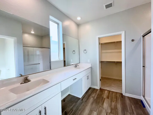 a bathroom with a sink double vanity and a mirror
