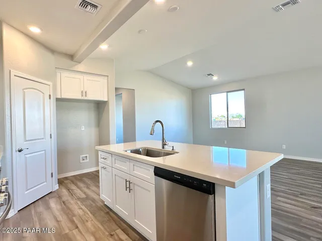 a kitchen with a sink appliances and cabinets