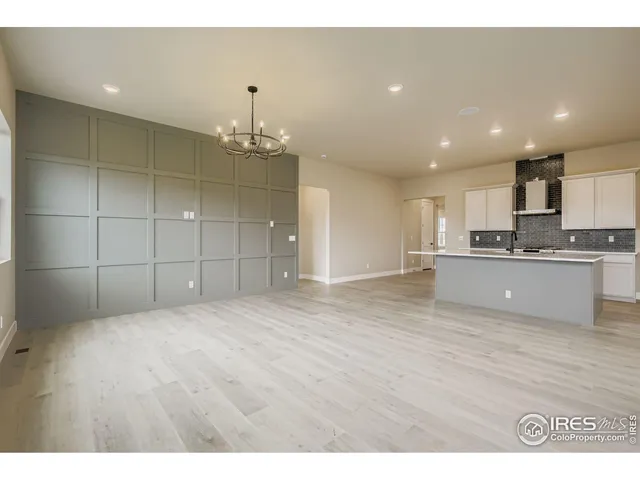 a view of an empty room with window and cabinet