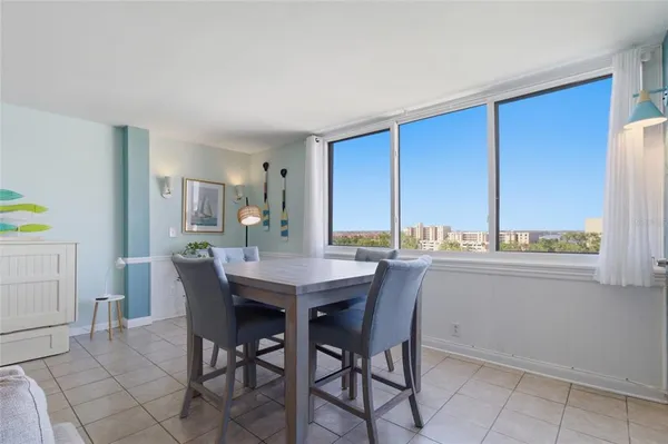 a dining room with a wooden table and chairs