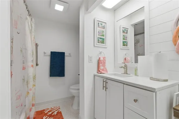 a bathroom with a sink toilet and shower
