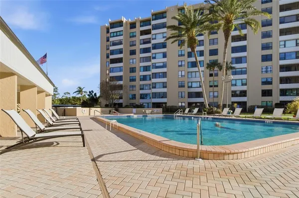 a view of swimming pool with seating space