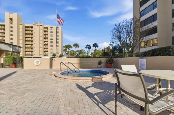 a balcony with table and chairs