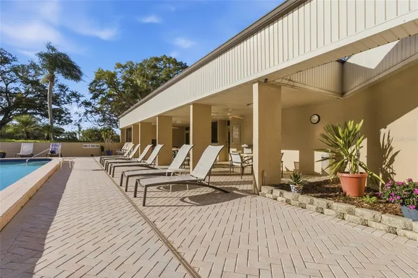 a living room with furniture and a dining table with kitchen view