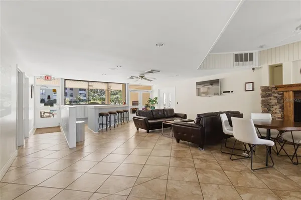 a dining room with furniture wooden floor and a fireplace
