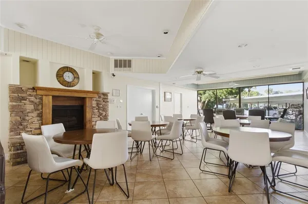 a room with pool table and windows