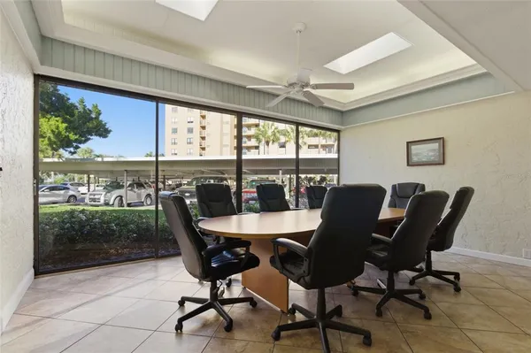 a dining room with furniture a large window and a fireplace