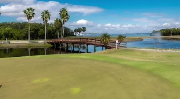 a view of a tall building next to a road