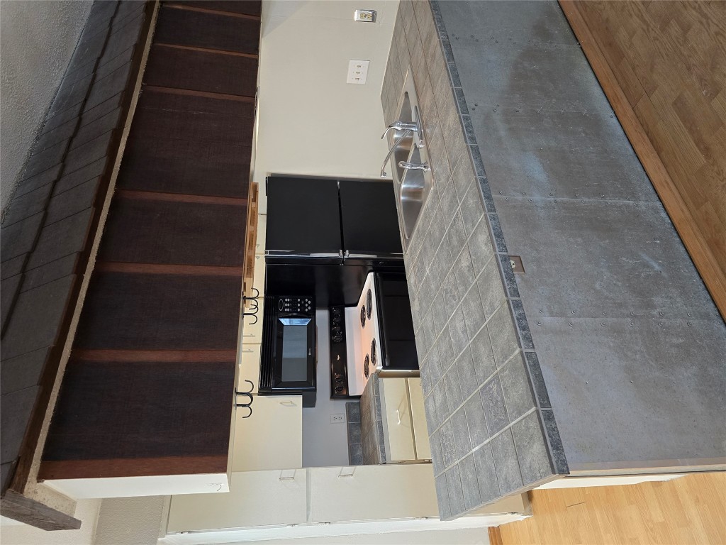 910 Duncan Lane, Unit 56 Austin, TX 78705 - Photo 4 of 13 a kitchen with kitchen countertops and cabinets