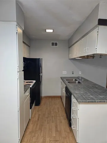 a kitchen with granite countertop a stove and a refrigerator