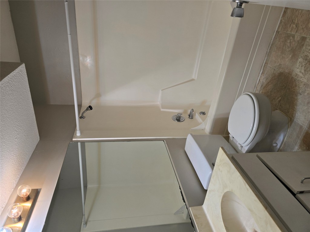 910 Duncan Lane, Unit 56 Austin, TX 78705 - Photo 7 of 13 a bathroom with a sink a toilet and shower