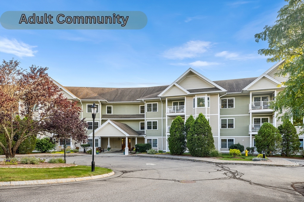 490 Main Street, Unit 215 Northborough, MA 01532 - Photo 1 of 37 a front view of a house with a yard